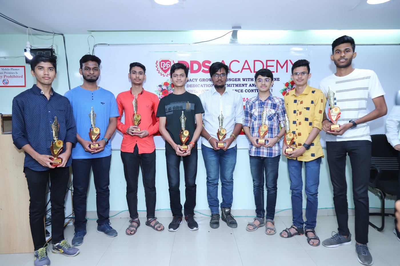 DDS Academy students holding trophies